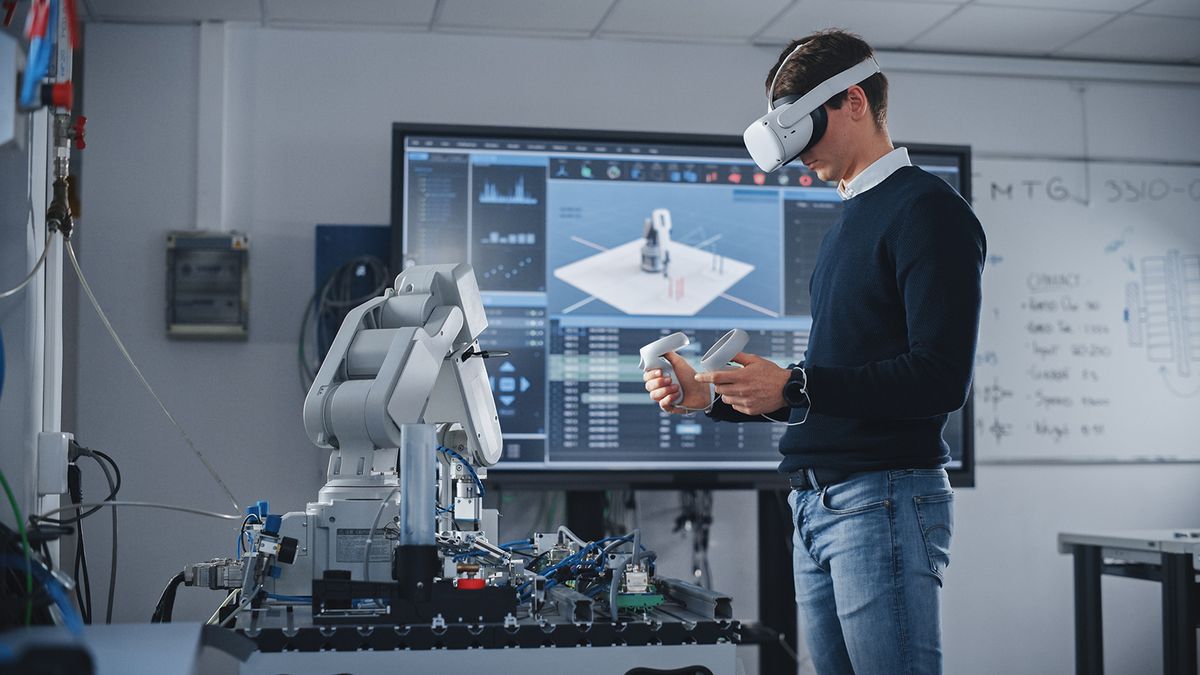 Student,Engineer,Using,Virtual,Reality,Software,For,His,Project.,Man
Student Engineer Using Virtual Reality Software for His Project. Man with Headset and Controllers Studying at Modern University in Classroom. Futuristic and High Tech Concept