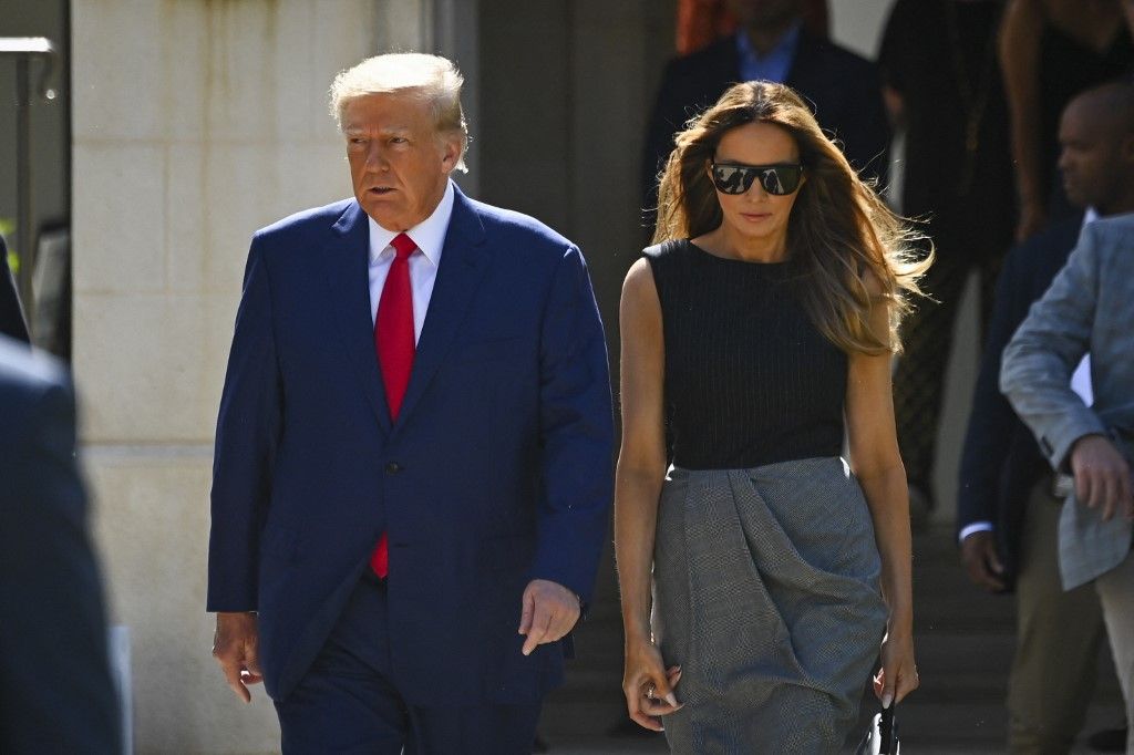 Former US President Donald Trump and his wife,  Melania Trump, leave a polling station after voting in the US midterm elections in Palm Beach, Florida, on November 8, 2022. (Photo by Eva Marie UZCATEGUI / AFP)