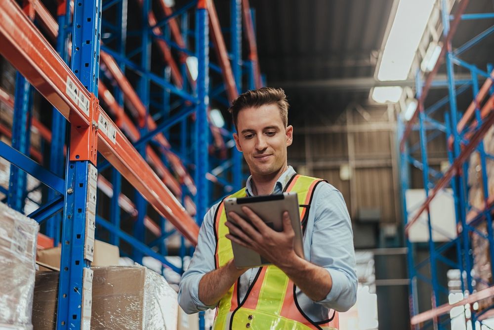 Warehouse,Workers,Checking,Stock,With,Digital,Tablet,In,Logistic,Center.