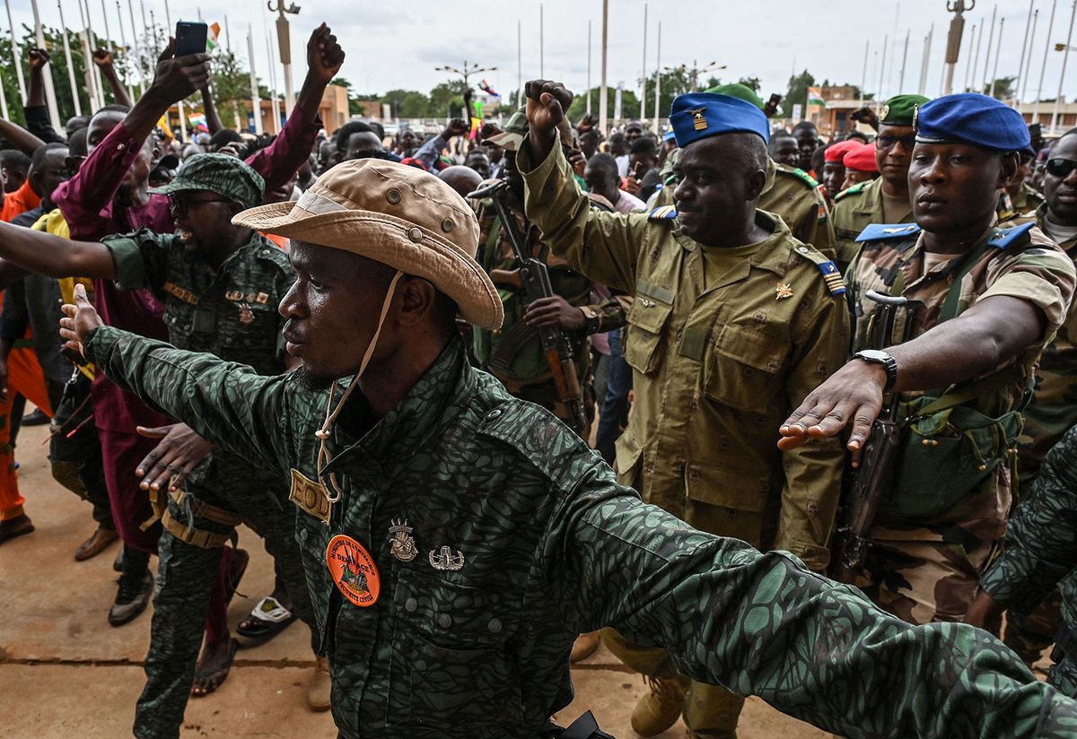 Niger's National Council for the Safeguard of the Homeland (CNSP) Colonel-Major Amadou Abdramane (2nd R) is greeted by supporters upon his arrival at the Stade General Seyni Kountche in Niamey on August 6, 2023. Thousands of supporters of the military coup in Niger gathered at a Niamey stadium Sunday, when a deadline set by the West African regional bloc ECOWAS to return the deposed President Mohamed Bazoum to power is set to expire, according to AFP journalists. A delegation of members of the ruling National Council for the Safeguard of the Homeland (CNSP) arrived at the 30,000-seat stadium to cheers from supporters, many of whom were drapped in Russian flags and portraits of CNSP leaders. (Photo by AFP) / “The erroneous mention[s] appearing in the metadata of this photo by - has been modified in AFP systems in the following manner: [Colonel-Major Amadou Abdramane] instead of [Colonel-Major Amadou Adramane]. Please immediately remove the erroneous mention[s] from all your online services and delete it (them) from your servers. If you have been authorized by AFP to distribute it (them) to third parties, please ensure that the same actions are carried out by them. Failure to promptly comply with these instructions will entail liability on your part for any continued or post notification usage. Therefore we thank you very much for all your attention and prompt action. We are sorry for the inconvenience this notification may cause and remain at your disposal for any further information you may require.”