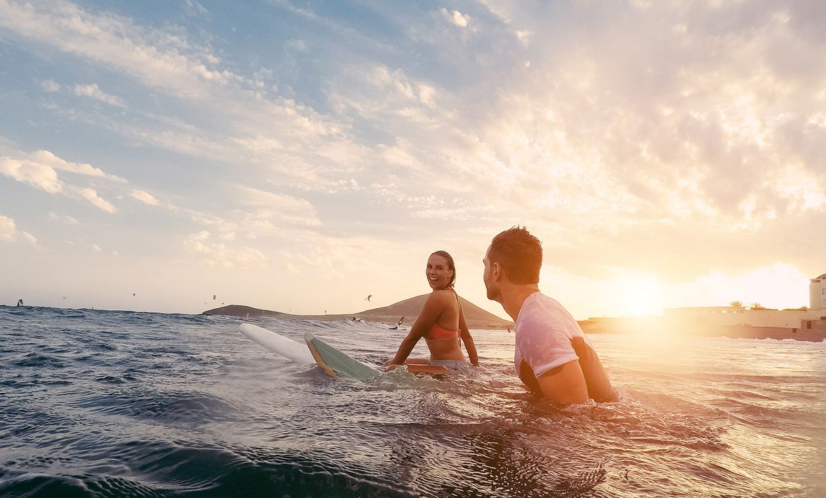 Fit,Couple,Surfing,At,Sunset,-,Surfers,Friends,Having,Fun