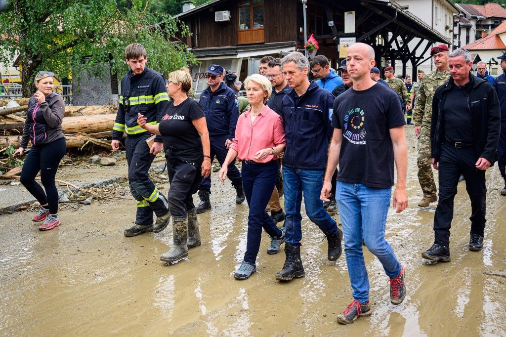 EU Commission President Ursula von der Leyen (C) visits flood-hit areas with Slovenian Prime Minister Robert Golob (3rd R) in Crna na Koroskem on August 9, 2023, as Slovenia, an EU member, has asked for help from the bloc, seeking in particular heavy machinery such as excavators and prefabricated temporary bridges to deal with the aftermath of the flooding. The death toll from days of heavy rains and flooding in Slovenia has climbed to six, police said on August 7, 2023. (Photo by Jure Makovec / AFP)