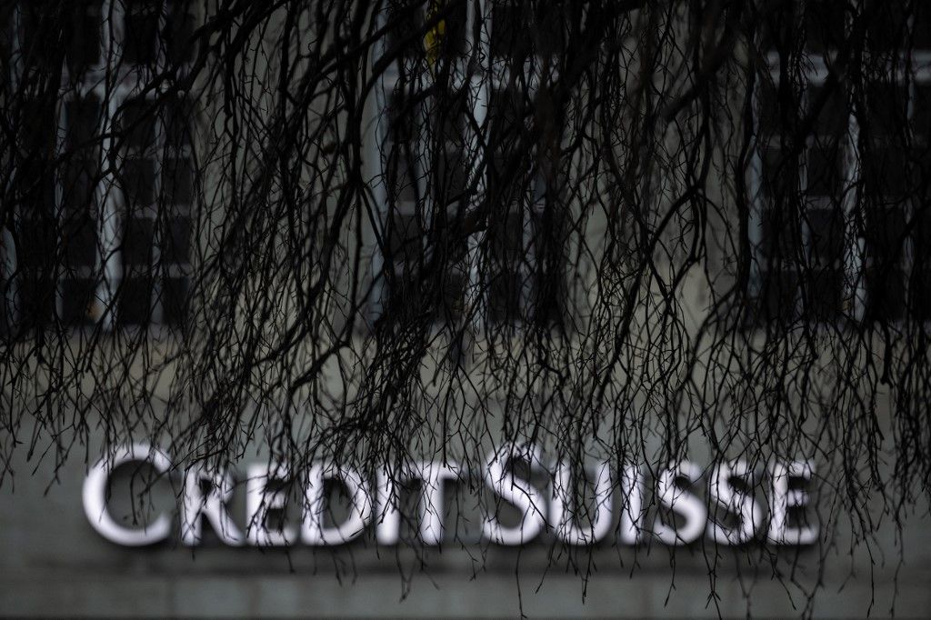 A sign of Credit Suisse bank is seen in Bern on March 19, 2023. UBS was up against the clock on March 19, 2023 in talks to finalise a mammoth takeover of its troubled rival Swiss bank Credit Suisse and reassure investors before the markets reopen. Switzerland's biggest bank UBS is being urged by the authorities to get a deal over the line in a bid to avoid a wave of contagious panic on the markets Monday, according to several media reports. (Photo by Fabrice COFFRINI / AFP)
