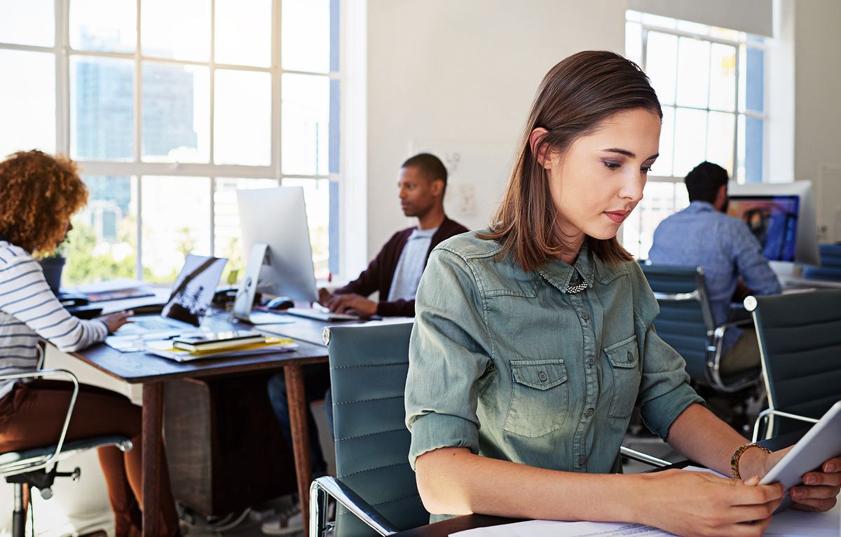 Woman,,Reading,Tablet,And,Focus,In,Office,At,Web,Design