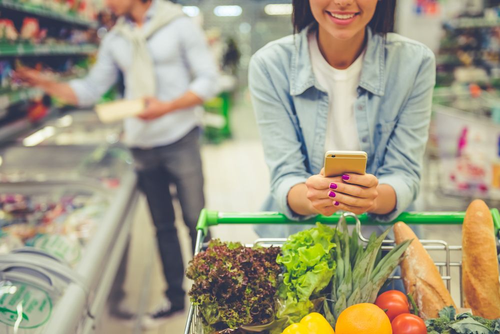Couple,In,The,Supermarket.,Cropped,Image,Of,Girl,Leaning,On