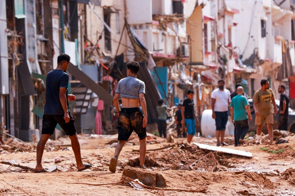 People check an area damaged by flash floods in Derna, eastern Libya, on September 11, 2023. Flash floods in eastern Libya killed more than 2,300 people in the Mediterranean coastal city of Derna alone, the emergency services of the Tripoli-based government said on September 12. (Photo by AFP)