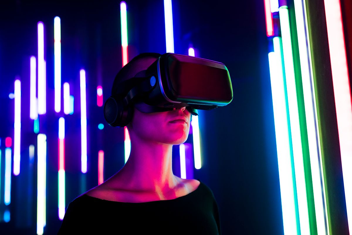 Woman wearing virtual reality simulator near colorful illuminated lights
Woman wearing virtual reality simulator near colorful illuminated lights