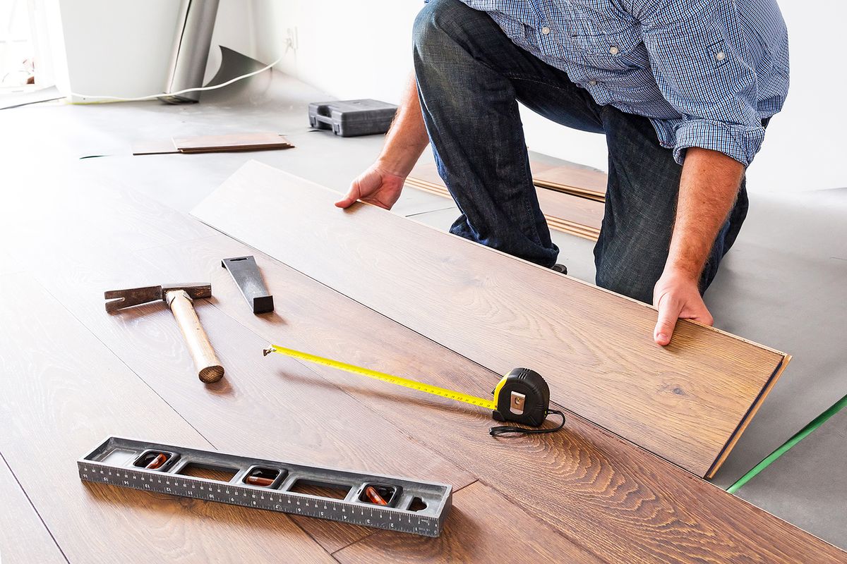 Man,Installing,New,Laminated,Wooden,Floor
Man installing new laminated wooden floor