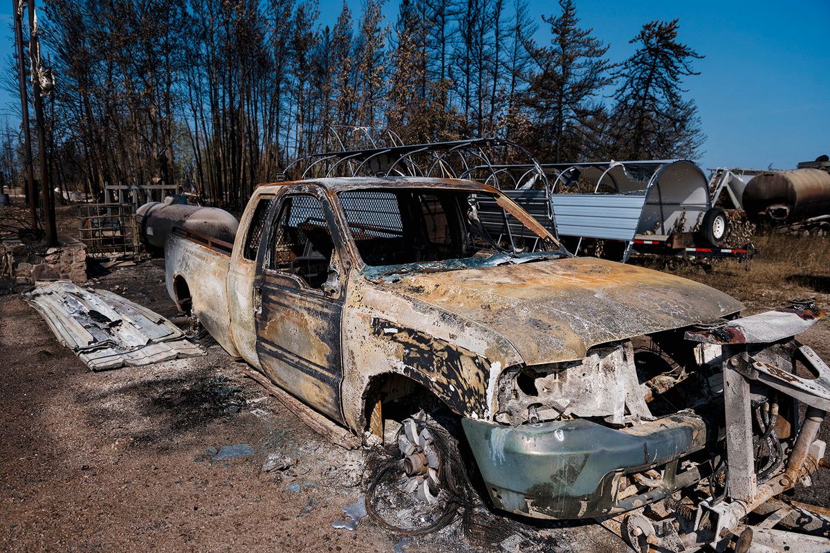 Charred remains are seen on the side of the road beside the highway in Enterprise, Northwest Territories, Canada, on August 20, 2023. Enterprise and Hay River were put on evacuation orders prior to the city of Yellowknife. The town of Enterprise, Northwest Territories, was burned to the ground by forest fires. Residents of Yellowknife in Canada's far north raced on August 18 to evacuate ahead of a midday deadline as wildfires bear down on the remote city and other parts of the vast country. (Photo by ANDREJ IVANOV / AFP)