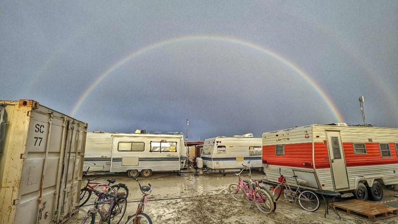 This handout image provided courtesy of Josh Lease on September 3, 2023 shows a double rainbow over flooding on a desert plain on September 1, 2023, after heavy rains turned the annual Burning Man festival site in Nevada’s Black Rock desert into a mud pit. Tens of thousands of drenched festivalgoers were stranded on September 3, 2023, in deep, sticky mud in the Nevada desert after torrential rain turned the annual Burning Man gathering into a quagmire. All events at the counterculture festival, which drew some 70,000 people, were canceled after rain tore down structures for dance parties, art installations and other eclectic entertainment. (Photo by Josh Lease / UGC / AFP) / RESTRICTED TO EDITORIAL USE - MANDATORY CREDIT "AFP PHOTO / Josh Lease" - NO MARKETING NO ADVERTISING CAMPAIGNS - DISTRIBUTED AS A SERVICE TO CLIENTS
