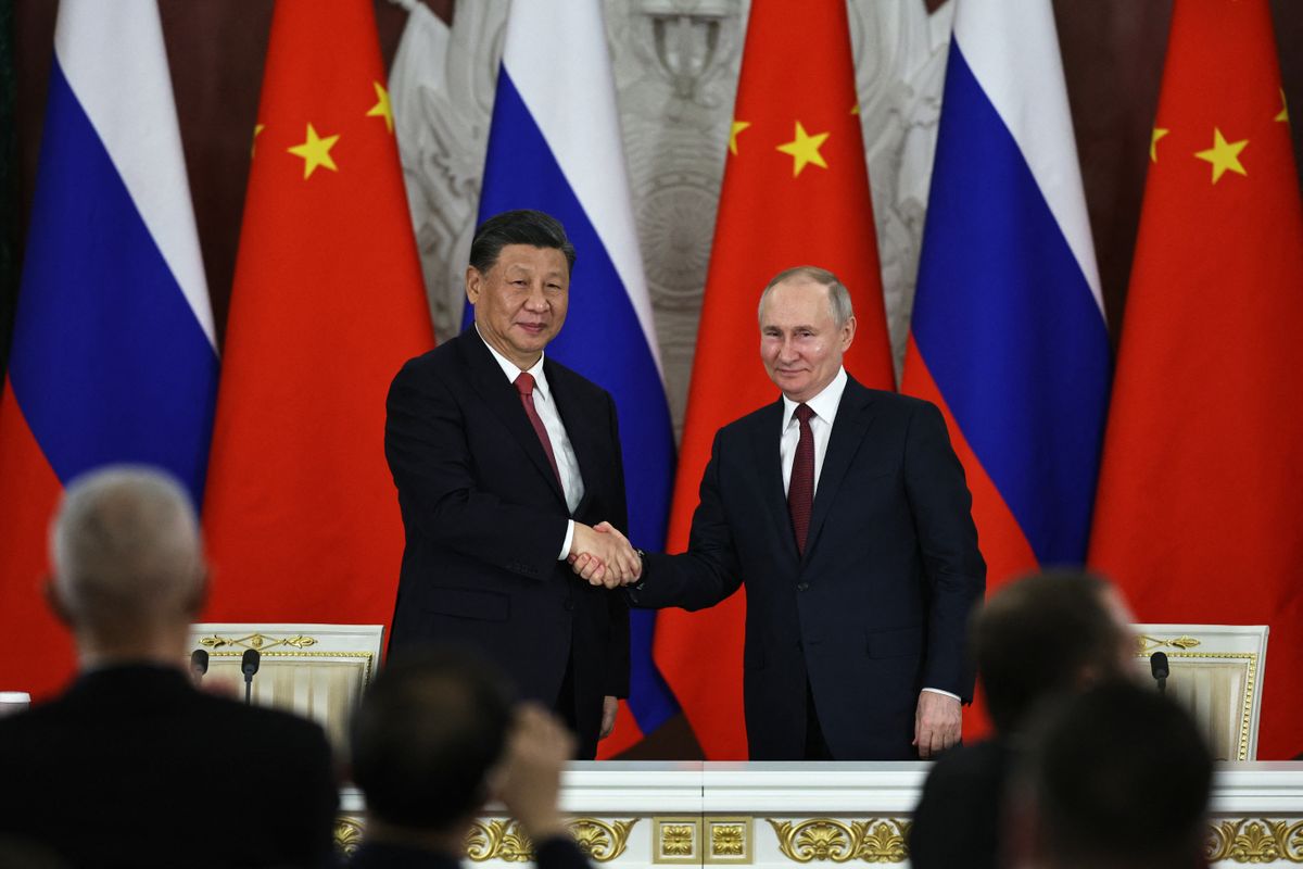 Russian President Vladimir Putin and China's President Xi Jinping shake hands after delivering a joint statement following their talks at the Kremlin in Moscow on March 21, 2023. (Photo by Mikhail TERESHCHENKO / SPUTNIK / AFP)
