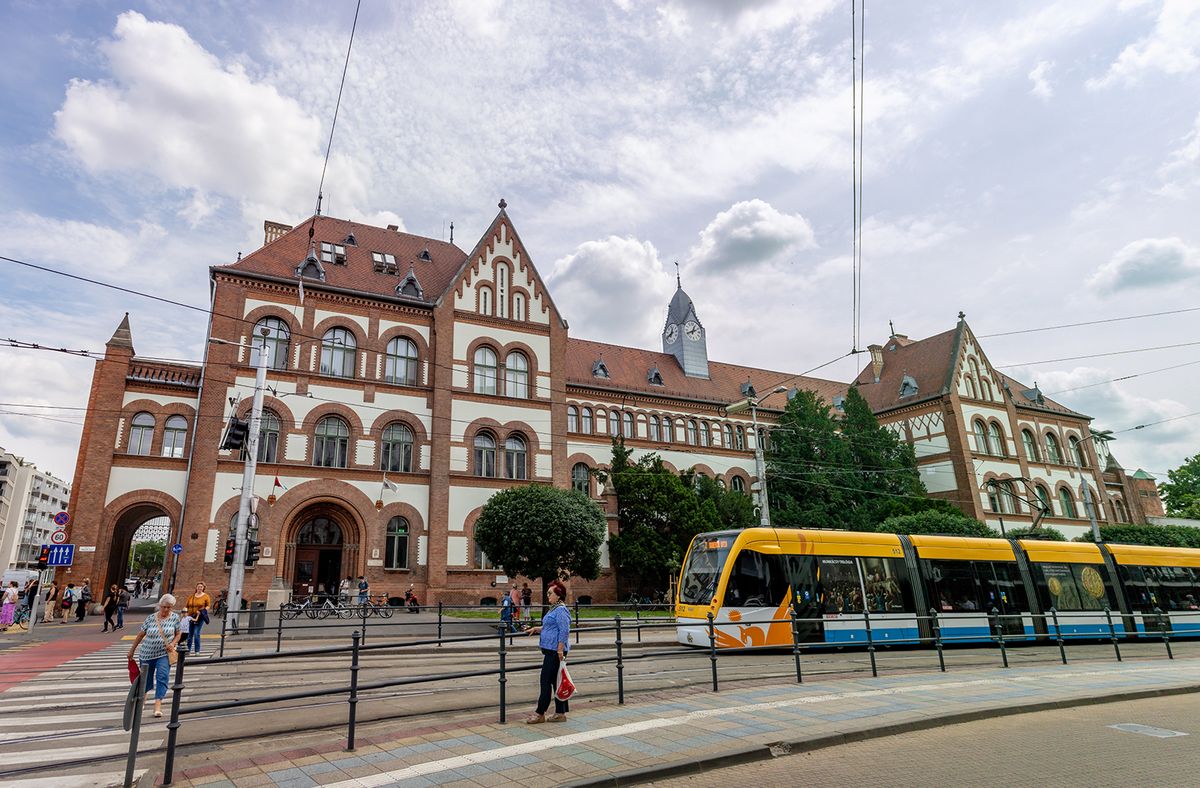 Debrecen,,Hungary,-,June,15th,2023:,Tram,Stop,In,Front,Debrecen, Hungary - June 15th 2023: Tram stop in front of the Debrecen Reformed College Primary School