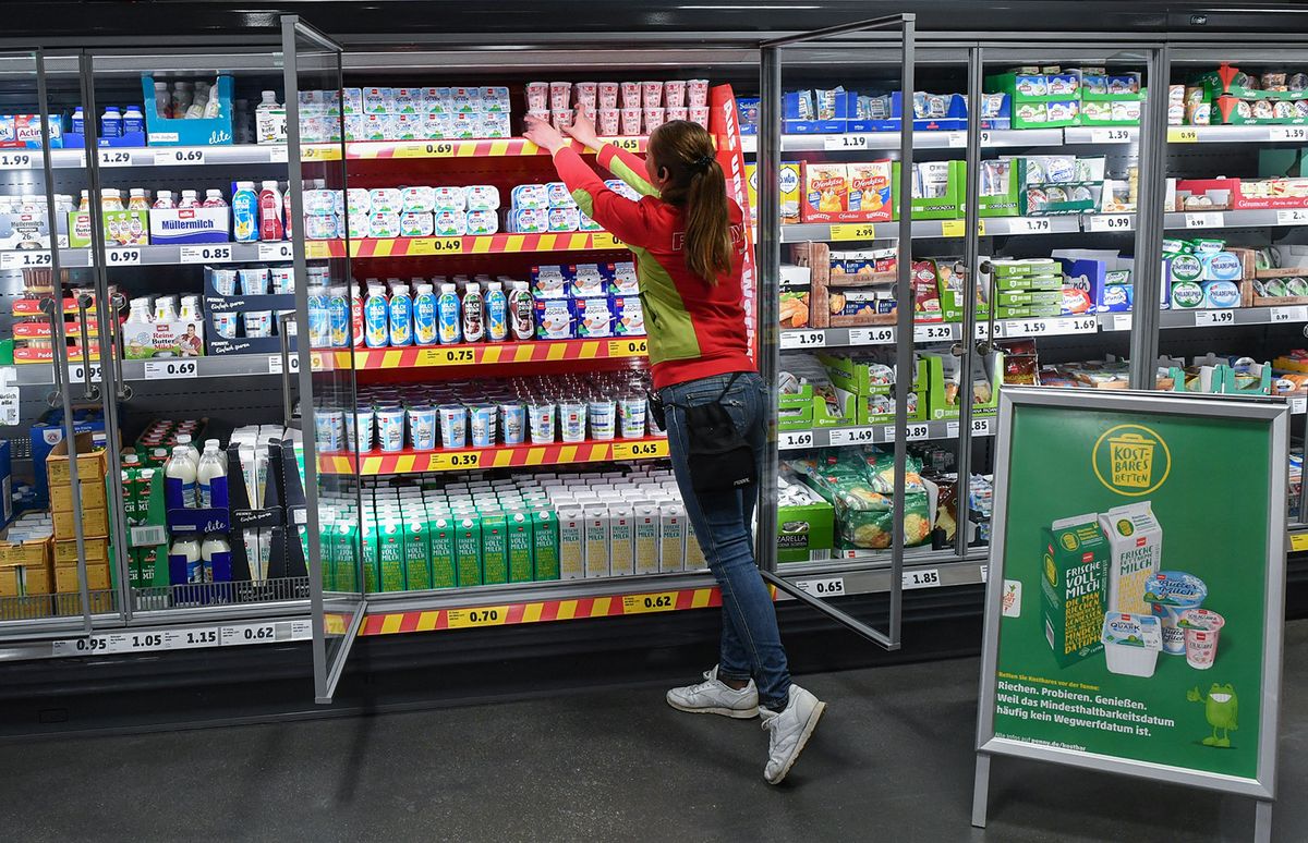 Campaign against food waste
22 February 2019, Berlin: An employee arranges the milk products in a refrigerated shelf in the Penny grocery discounter, in front of which the operator stands with the advertising of the "Save precious items" campaign. The nationwide campaign, which aims to reduce food waste, was launched today. The minimum shelf life date is often understood as a disposable date, but many products can be enjoyed for even longer. Photo: Jens Kalaene/dpa (Photo by JENS KALAENE / DPA / dpa Picture-Alliance via AFP)