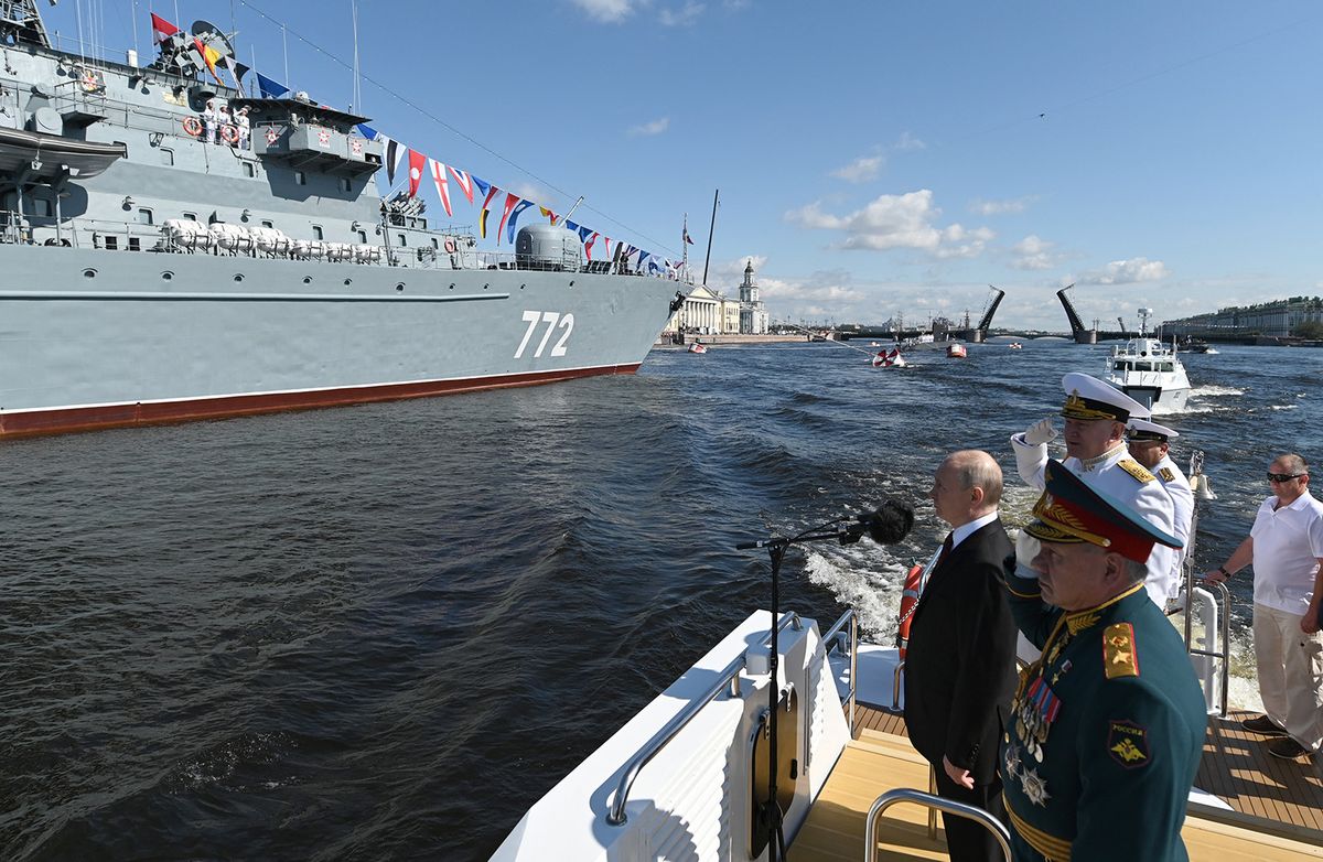 This pool image distributed by Sputnik agency shows Russian President Vladimir Putin, accompanied by Defence Minister Sergei Shoigu and Commander-in-Chief of the Russian Navy, Admiral Nikolai Yevmenov, attending the Navy Day parade in Saint Petersburg on July 30, 2023. (Photo by Alexander KAZAKOV / POOL / AFP)