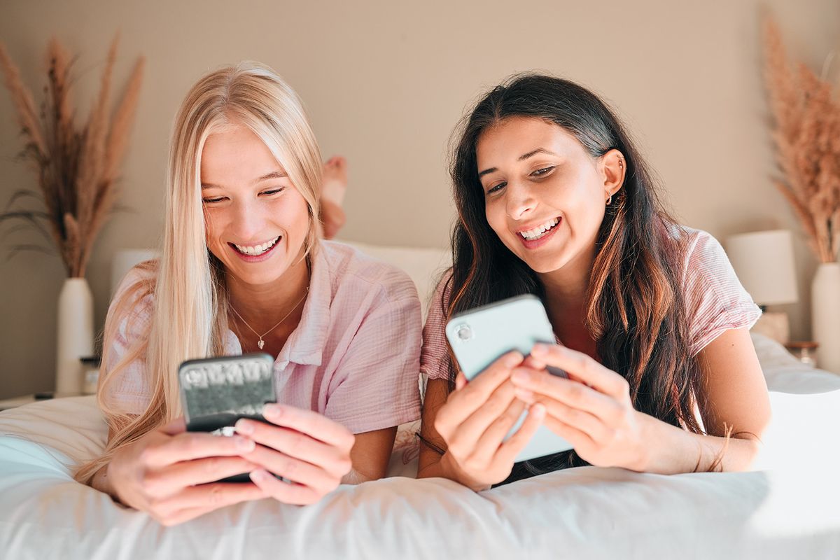 Teen,Friends,,Smartphone,And,Girl,On,Bed,,Relax,And,Smile