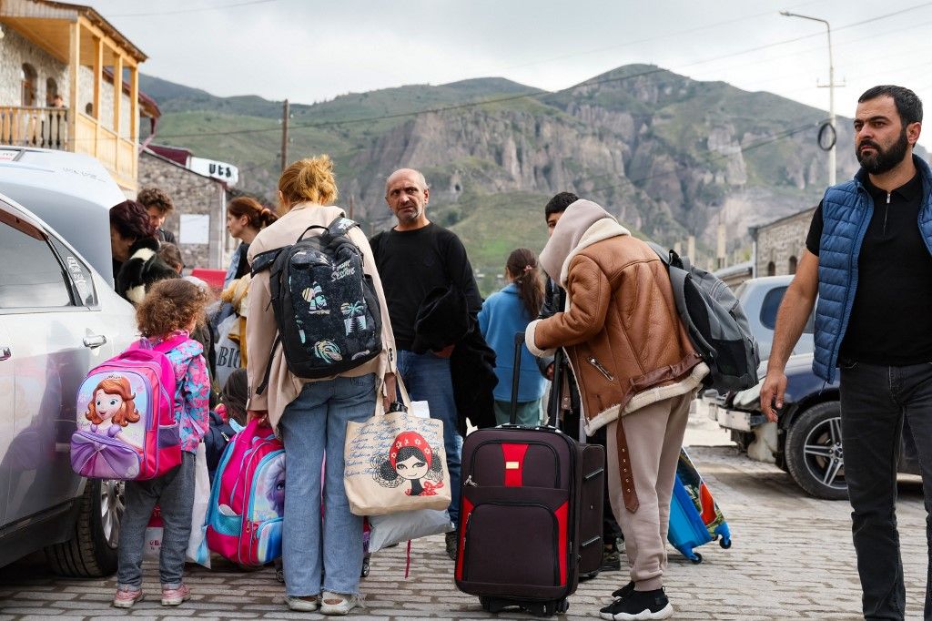 Refugees load their cars as they leave the Red Cross registration center, in Goris, on September 25, 2023. The first group of Nagorno-Karabakh refugees since Azerbaijan's lighting assault against the separatist region entered Armenia on September 24, 2023, an AFP team at the border said. The group of a few dozen people passed by Azerbaijani border guards before entering the Armenian village of Kornidzor, where they were registered by officials from Armenia's foreign ministry. (Photo by ALAIN JOCARD / AFP)