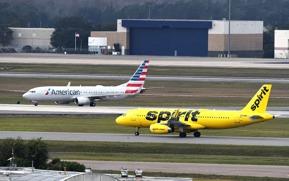 Holiday Travel Plagued By Flight Delays And Cancellations Across The U.S.January 2, 2022 - Orlando, Florida, United States - American Airlines and Spirit Airlines planes are seen arriving at Orlando International Airport on January 2, 2022 in Orlando, Florida. Holiday travel was plagued by thousands of cancelled and delayed flights in the United States, caused by bad weather and flight crew shortages due to the COVID-19 Omicron variant.  (Photo by Paul Hennessy/NurPhoto) (Photo by Paul Hennessy / NurPhoto / NurPhoto via AFP)
