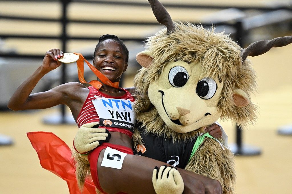 Bahrain's Winfred Mutile Yavi celebrates with her gold medal as she is carried by Youhuu the mascot after the women's 3000m steeplechase final during the World Athletics Championships at the National Athletics Centre in Budapest on August 27, 2023. (Photo by Attila KISBENEDEK / AFP)