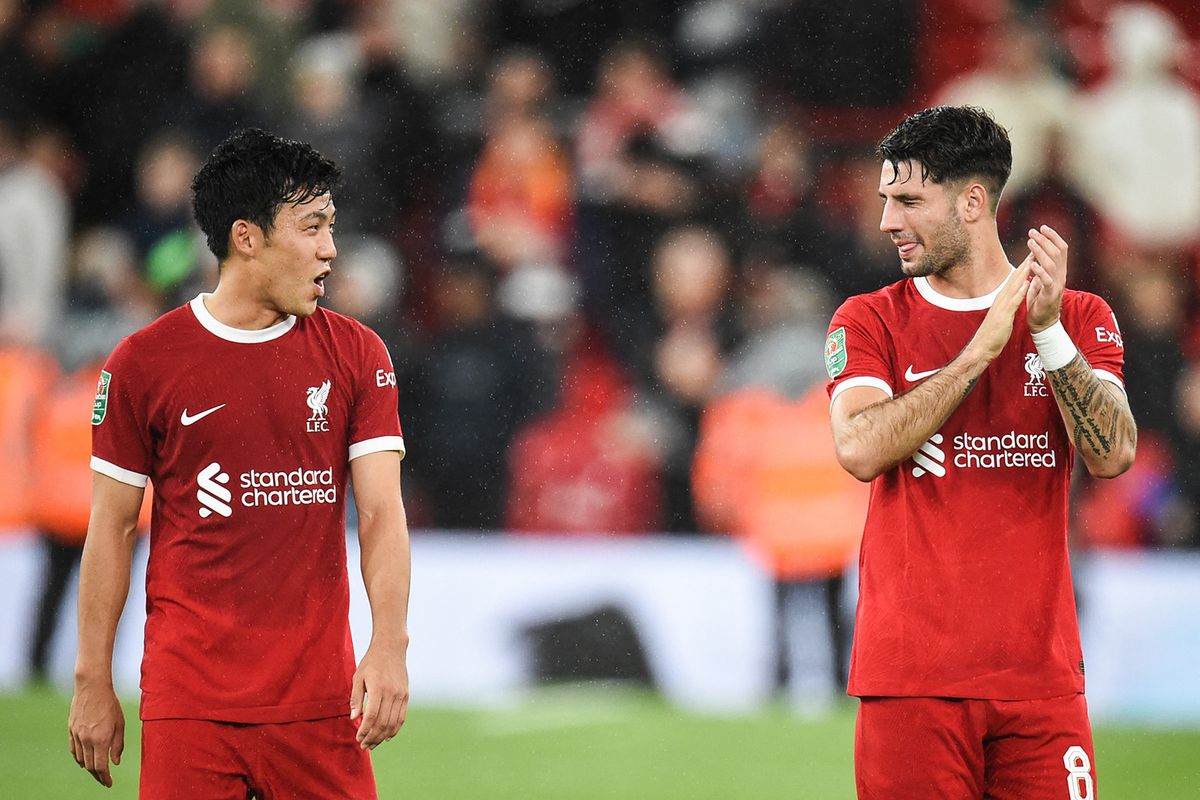 Liverpool's Japanese midfielder #03 Wataru Endo (L) and Liverpool's Hungarian midfielder #08 Dominik Szoboszlai react at the end of the English League Cup third round football match between Liverpool and Leicester City at Anfield in Liverpool, north west England on September 27, 2023. Liverpool wins 3 - 1 against Leicester City. (Photo by PETER POWELL / AFP) / RESTRICTED TO EDITORIAL USE. No use with unauthorized audio, video, data, fixture lists, club/league logos or 'live' services. Online in-match use limited to 120 images. An additional 40 images may be used in extra time. No video emulation. Social media in-match use limited to 120 images. An additional 40 images may be used in extra time. No use in betting publications, games or single club/league/player publications. /