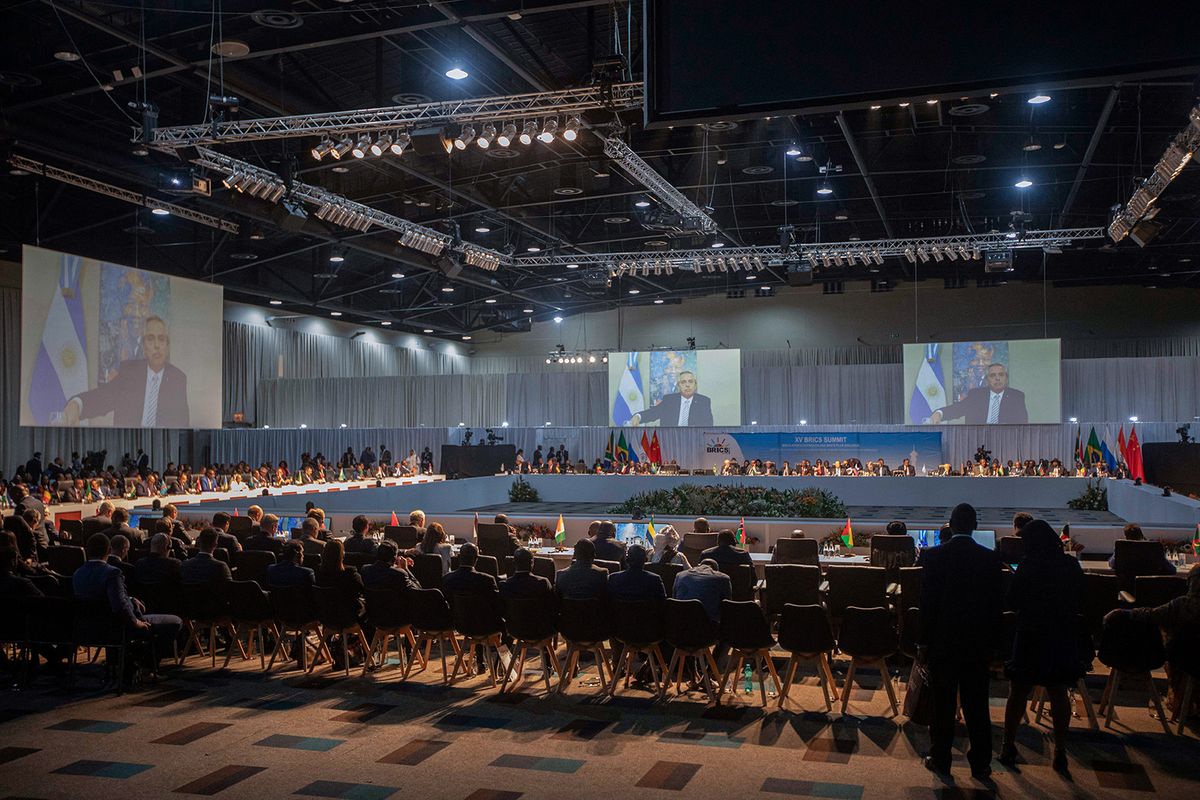 A screen shows the President of Argentina delivering remarks at a meeting during the 2023 BRICS Summit at the Sandton Convention Centre in Johannesburg on August 24, 2023. (Photo by Kim LUDBROOK / POOL / AFP)
