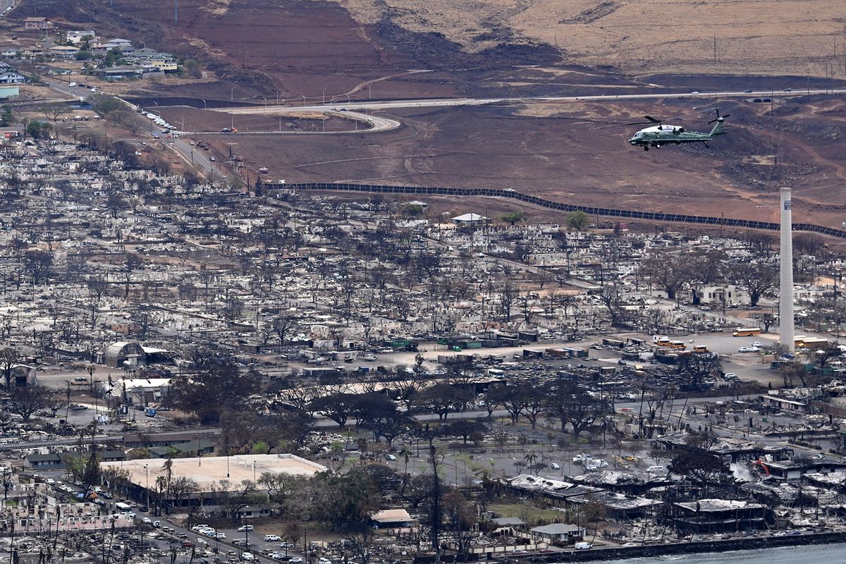 Marine One, carrying US President Joe Biden, flies above wildfire damage in Lahaina on the island of Maui, in Hawaii on August 21, 2023. The Bidens are expected to meet with first responders, survivors, and local officials following deadly wildfires in Maui. (Photo by Mandel NGAN / AFP)