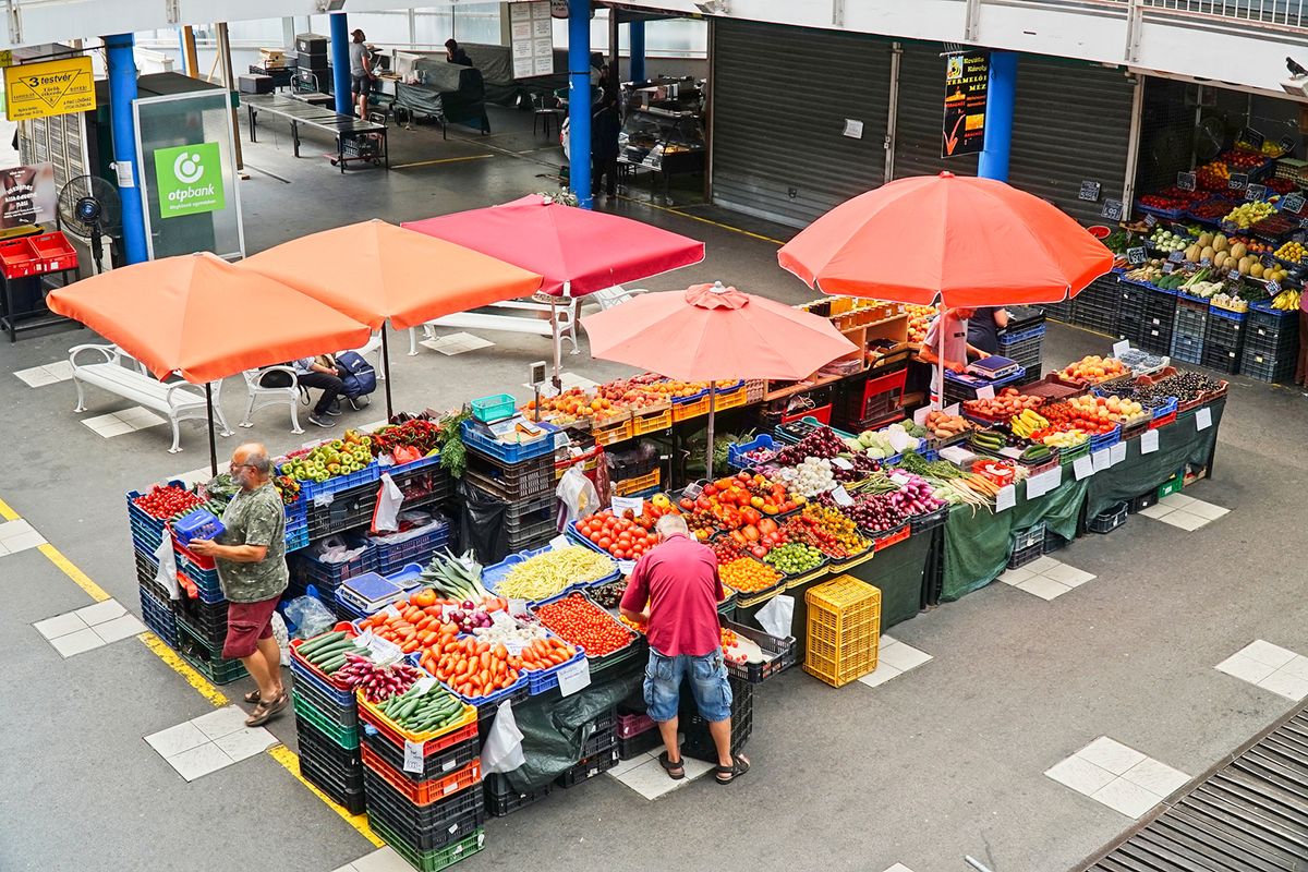 Budapest,,Hungary,-,Aug,3,,2023:,Colorful,Market,Stall,WithBudapest, Hungary - Aug 3, 2023: Colorful market stall with vegetables and fruits. View of a large food market with vendors  from above in Budapest, Hungary in summer.