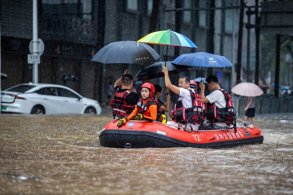 Rescue workers ride a boat along a flooded street in Shenzhen, in China's Guangdong province on September 8, 2023, after the city recorded the heaviest rains since records began in 1952. (Photo by AFP) / China OUT