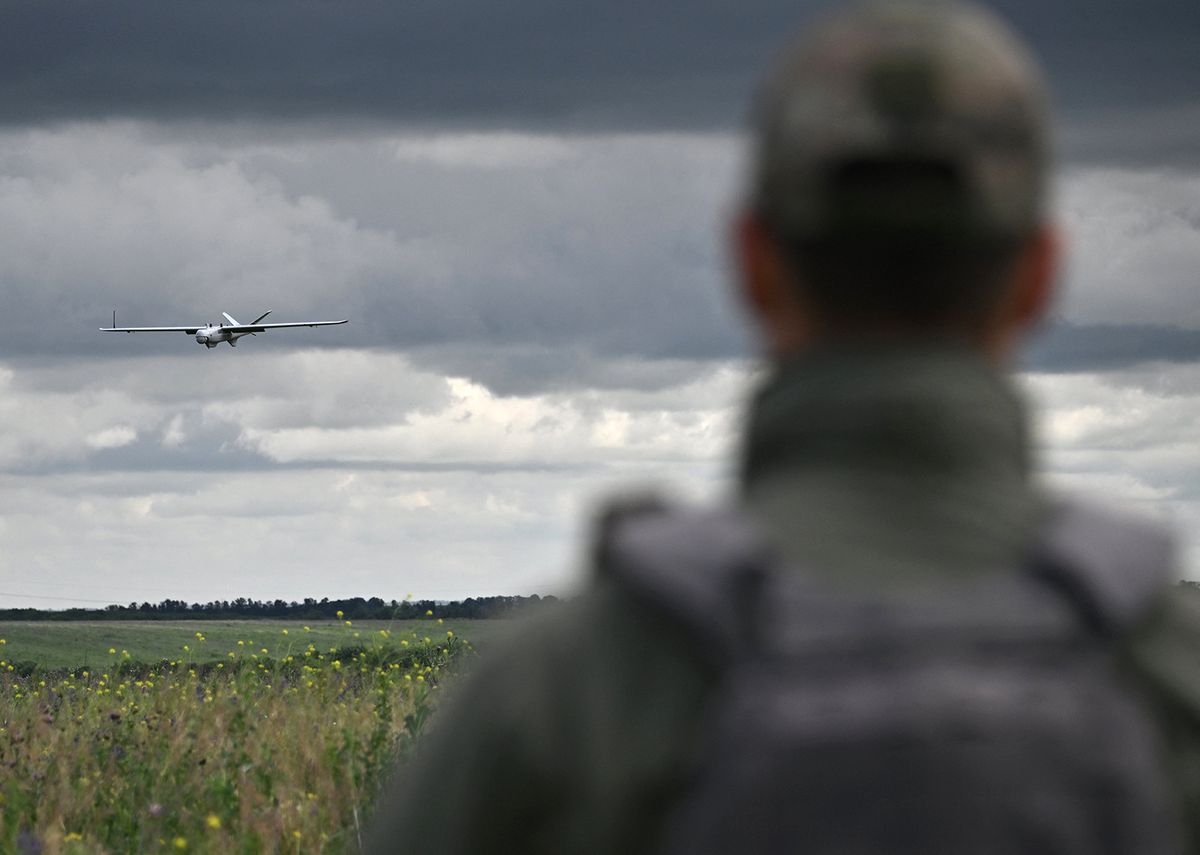 A Ukrainian serviceman of an air reconnaissance squad of the 45th Brigade controls a Leleka reconnaissance UAV during its landing at a position in Donetsk region on June 27, 2023, amid the Russian invasion of Ukraine. (Photo by Genya SAVILOV / AFP)