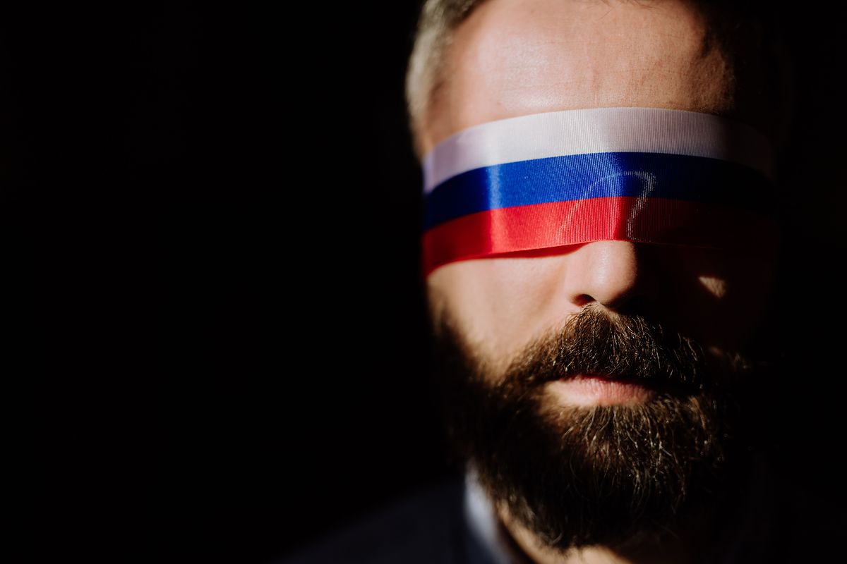 Man,With,Russian,Flag,Blindfold,On,Black,Background,,Russian,Propaganda