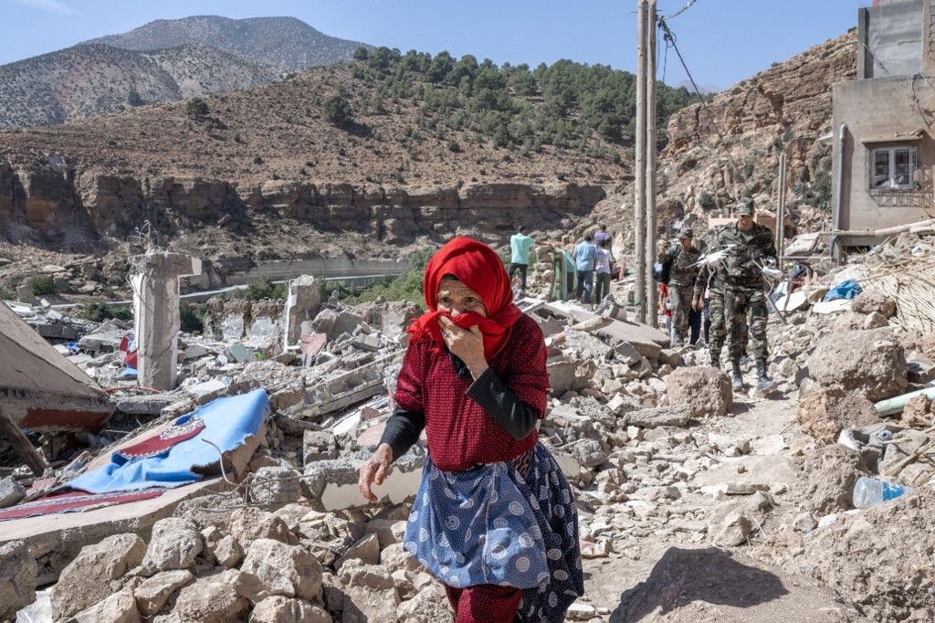 A woman walks amid debris in the earthquake-hit village of Imi N’Tala on September 19, 2023. Nearly 3,000 people were killed and thousands more injured when a 6.8-magnitude earthquake tit Morocco's Al-Haouz province on September 8. In its aftermath, many worry that the dire living conditions and poor hygiene spell new threats for the survivors. (Photo by BULENT KILIC / AFP)