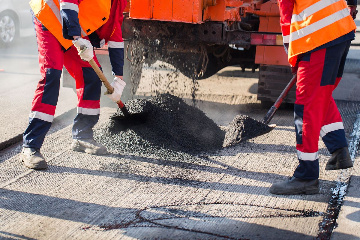 Young,Builder,On,Asphalting,Paver,Machine,During,Road,Street,Repairing