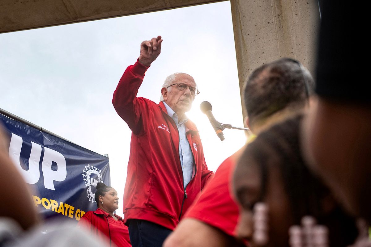US Senator Bernie Sanders (I-VT) speaks to members of the United Auto Workers (UAW) union during a rally in Detroit, Michigan, on September 15, 2023. Workers at the "Big Three" US auto manufacturers went on strike on September 15, 2023, in a first-ever coordinated action to demand pay raises, testing the resilience of the US economy and threatening President Joe Biden's 2024 re-election momentum. A dramatic walkout -- observed outside a Detroit-area Ford plant with rowdy honking and cheers at the arrival of the United Auto Workers' leader -- followed a failed last-minute push by General Motors, Ford and Stellantis to produce an agreement before the deadline late on September 14, 2023. (Photo by Matthew Hatcher / AFP)