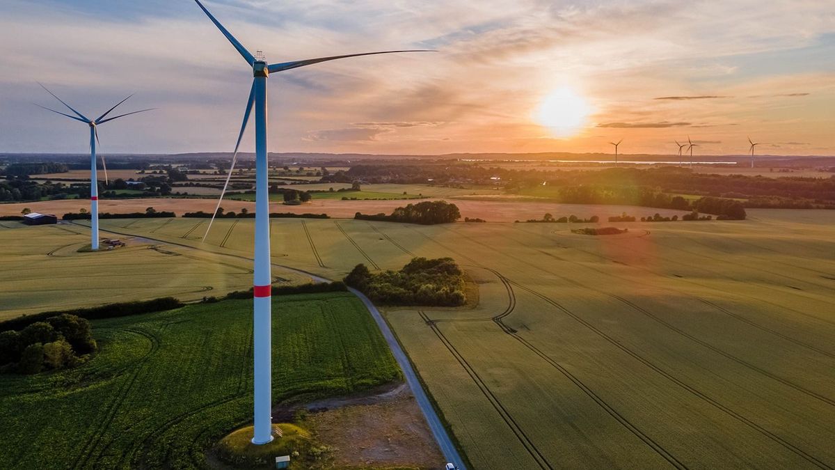Wind,Turbines,In,Wheat,Fields,In,Summer,At,Sunset.,Aerial