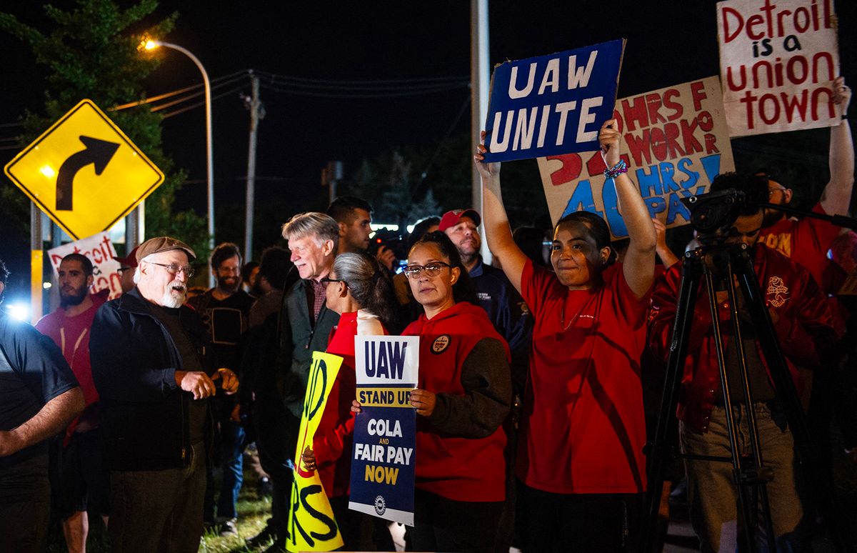 Members of the UAW (United Auto Workers) picket and hold signs outside of the UAW Local 900 headquarters across the street from the Ford Assembly Plant in Wayne, Michigan on September 15, 2023. The US auto workers' union announced the start of a strike at three factories just after midnight on Friday, September 15, as a deadline expired to reach a deal with employers on a new contract."Tonight, for the first time in our history, we will strike all three of the Big Three at once," UAW President Shawn Fain said in a webcast two hours before the midnight contract expiration at the three major automakers. (Photo by Matthew Hatcher / AFP)