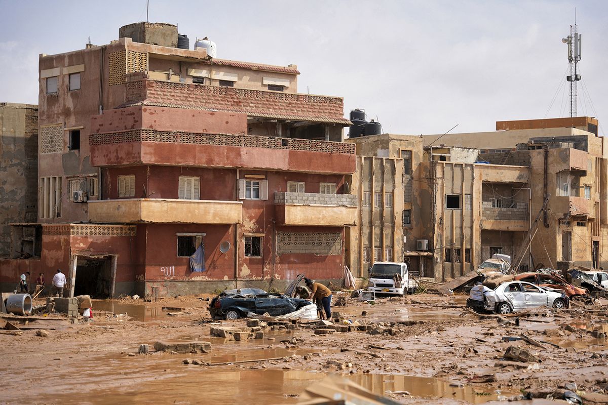 This handout picture provided by the office of Libya's Benghazi-based interim prime minister on September 11, 2023 shows a view of destroyed vehicles and damaged buildings in the eastern city of Derna, about 290 kilometres east of Benghazi, in the wake of the Mediterranean storm "Daniel". At least 150 people were killed when freak floods hit eastern Libya, officials said on September 11, after the storm's torrential rains battered Turkey, Bulgaria, and Greece. (Photo by The Press Office of Libyan Prime Minister / AFP) / === RESTRICTED TO EDITORIAL USE - MANDATORY CREDIT "AFP PHOTO / HO /MEDIA OFFICE OF LIBYAN PRIME MINISTER (BENGHAZI)" - NO MARKETING NO ADVERTISING CAMPAIGNS - DISTRIBUTED AS A SERVICE TO CLIENTS === / “The erroneous mention[s] appearing in the metadata of this photo by - has been modified in AFP systems in the following manner: [Derna, about 290 kilometres east of Benghazi] instead of [Benghazi]. Please immediately remove the erroneous mention[s] from all your online services and delete it (them) from your servers. If you have been authorized by AFP to distribute it (them) to third parties, please ensure that the same actions are carried out by them. Failure to promptly comply with these instructions will entail liability on your part for any continued or post notification usage. Therefore we thank you very much for all your attention and prompt action. We are sorry for the inconvenience this notification may cause and remain at your disposal for any further information you may require.”