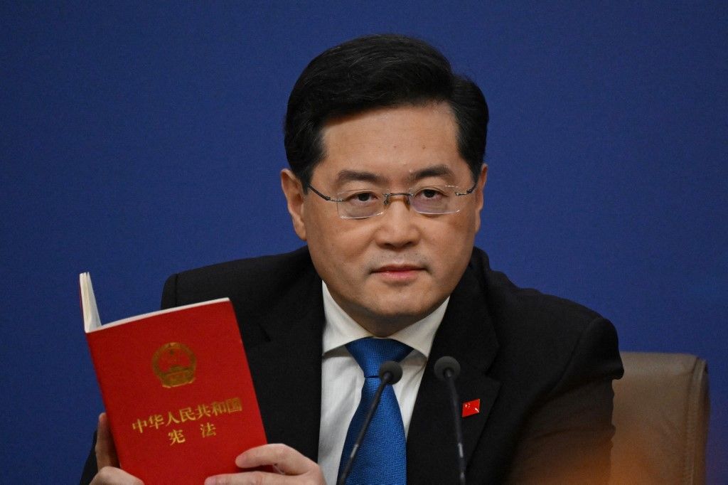 (FILES) China's Foreign Minister Qin Gang holds a copy of China's constitution during a press conference at the Media Center of the National People's Congress (NPC) in Beijing on March 7, 2023. Qin Gang, handpicked by President Xi Jinping as foreign minister, was abruptly replaced in July by the veteran policymaker Wang Yi. (Photo by NOEL CELIS / AFP)