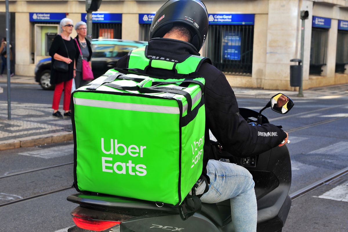 Lisbon,,Portugal,-,March,16:,Uber,Eats,Delivery,Courier,InLISBON, PORTUGAL - MARCH 16: Uber Eats delivery courier in the street of Lisbon city centre on March 16, 2019.