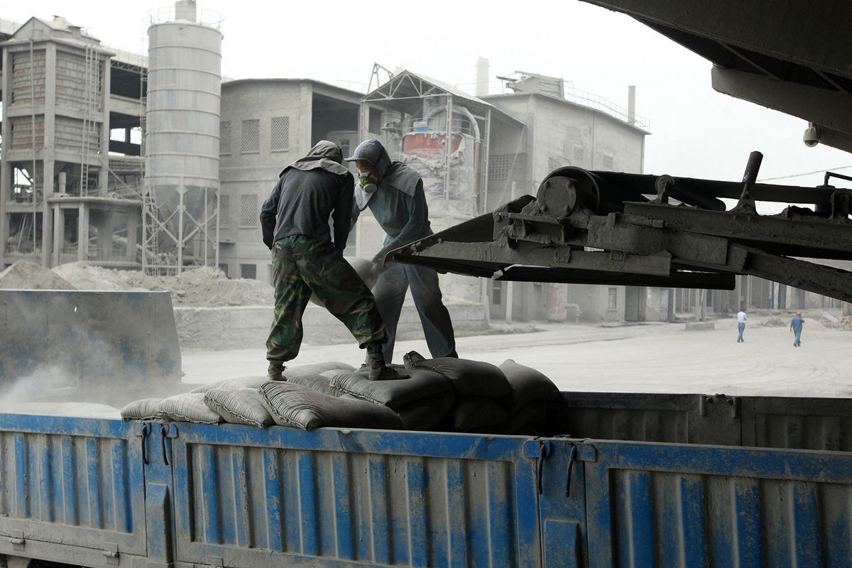 Workers at a cement factory in Huaibei, east China's Anhui province on September 8, 2009. China is heavily focused on infrastructure investment, and various economic indicators show it is starting to have an impact, with the latest production of cement, a key component in construction projects, increased 13.5 percent from a year earlier, the statistics bureau said.             AFP CHINA XTRA (Photo by 'ACOREANO ORIENTAL' / ZH0007 / China Xtra via AFP)