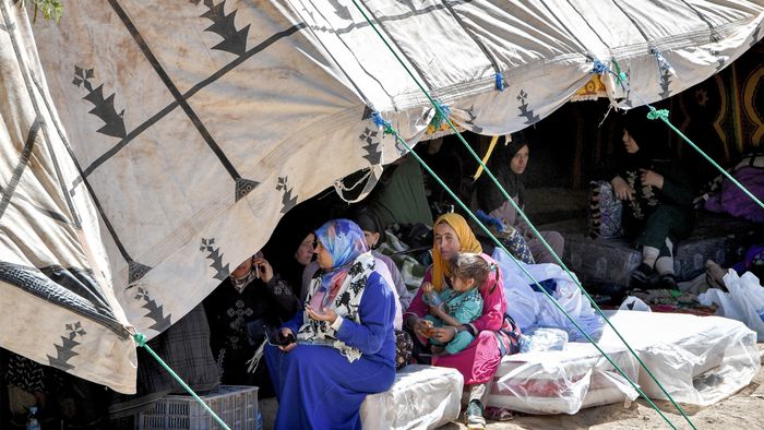 Survivors of the deadly 6.8-magnitude September 8 earthquake gather under a tent in the village of Tikht near Adassil in central Morocco on September 10, 2023. Using heavy equipment and even their bare hands, rescuers in Morocco on September 10 stepped up efforts to find survivors of a devastating earthquake that killed more than 2,100 people and flattened villages. (Photo by FETHI BELAID / AFP)