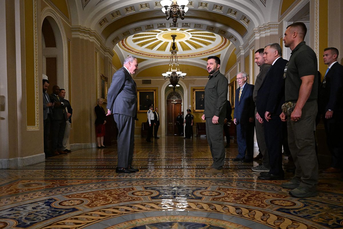 Ukrainian President Volodymyr Zelensky (C), accompanied by US Senate Majority Leader Chuck Schumer (L) and Senate Minority Leader Mitch McConnell (C R), departs after meeting with US Senators in the Old Senate Chamber, at the US Capitol in Washington, DC, on September 21, 2023. (Photo by PEDRO UGARTE / AFP)