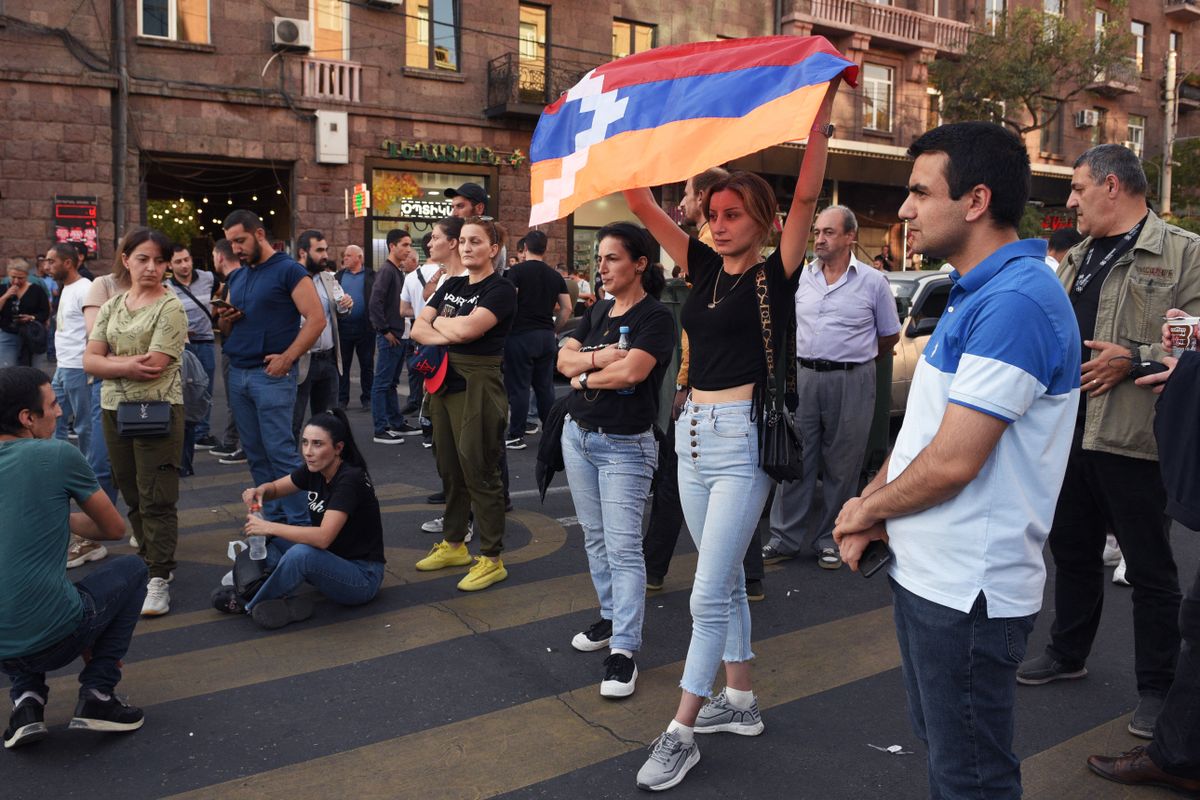 A woman holds a Karabakh flag as people attend a rally in Yerevan on September 21, 2023, following Azerbaijani military operations against Armenian separatist forces in Nagorno-Karabakh. Azerbaijan and Armenian separatists from the disputed territory of Nagorno-Karabakh held their first direct peace talks on September 21, 2023, after Baku claimed to have regained control over the breakaway region in a lightning military operation. (Photo by Karen MINASYAN / AFP)