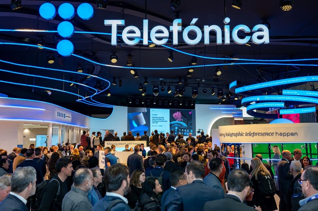 Mobile World Congress 2023, Barcelona In SpainVisitors walk at the Telefonica during the Mobile World Congress 2023 (MWC), the telecom industry's biggest annual gathering on February 28, 2023 in Barcelona, Spain. (Photo by Chris Jung/NurPhoto) (Photo by Chris Jung / NurPhoto / NurPhoto via AFP)