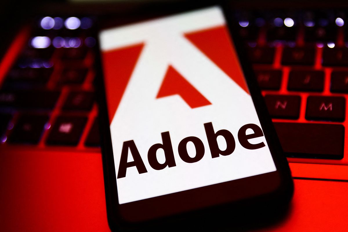Software Companies Photo Illustrations
Adobe logo displayed on a phone screen and a laptop keyboard are seen in this illustration photo taken in Krakow, Poland on October 30, 2021. (Photo by Jakub Porzycki/NurPhoto) (Photo by Jakub Porzycki / NurPhoto / NurPhoto via AFP)