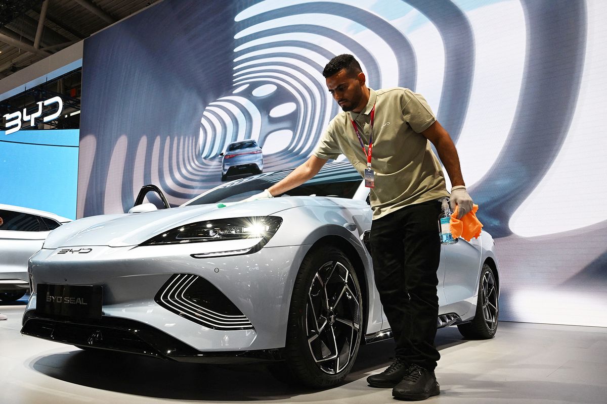 A man polishes a Seal car of Chinese car maker BYD at the International Motor Show (IAA) in Munich, southern Germany, on September 4, 2023. Germany's IAA MOBILITY auto show, one of the world's largest, will be open for the public from September 5 to 10, 2023 and showcase all car-related topics. (Photo by CHRISTOF STACHE / AFP)