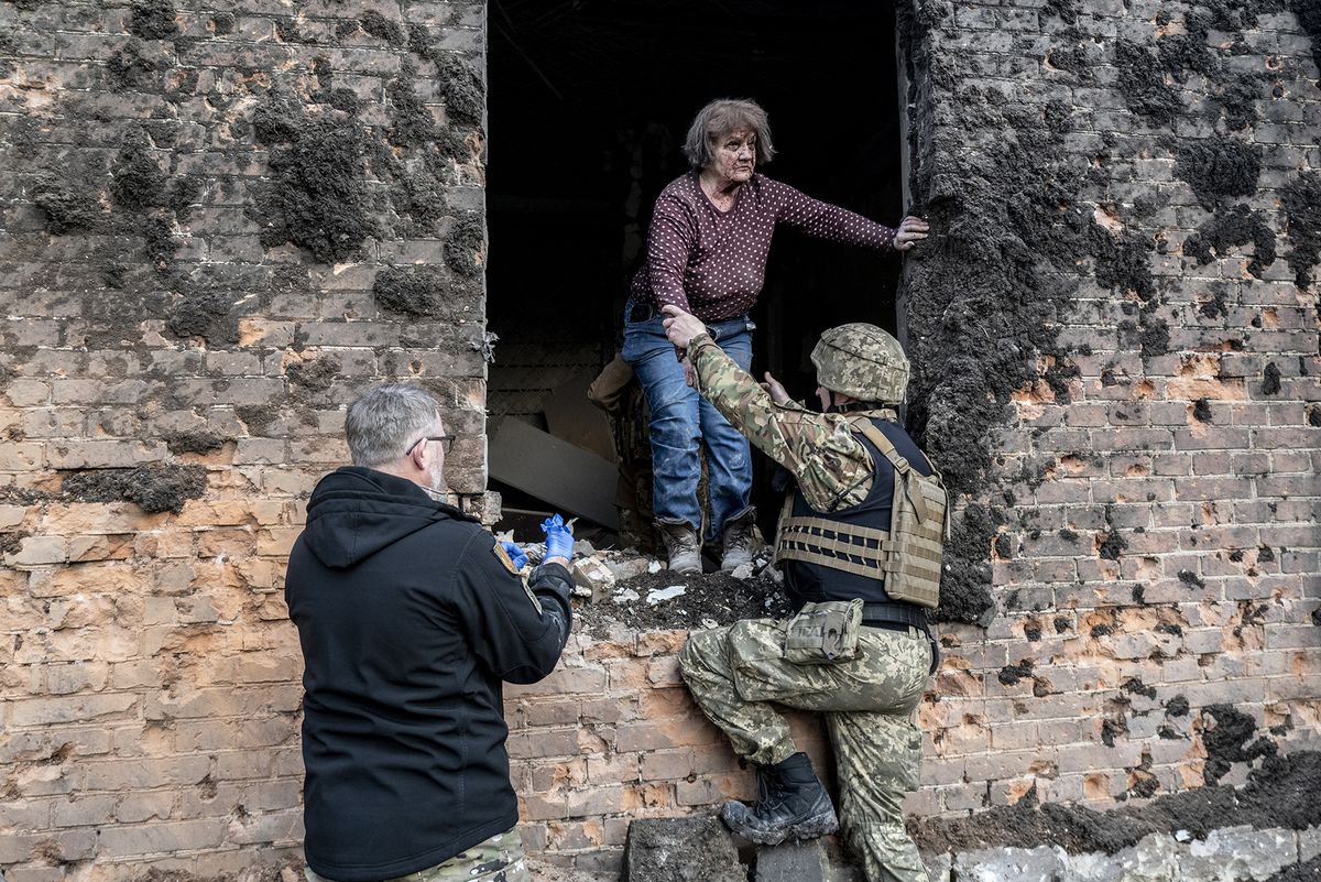 3 died after Russian shelling in Kostyantynivka
KOSTYANTYNIVKA, DONETSK OBLAST, UKRAINE - APRIL 02: Ukrainian soldiers help an injured woman after Russian shelling of the town center of Kostyantynivka as the Russian-Ukraine war continues in Ukraine on April 02, 2023. At least three people died after the Russian attack. (Photo by Marek M. Berezowski/Anadolu Agency via Getty Images)