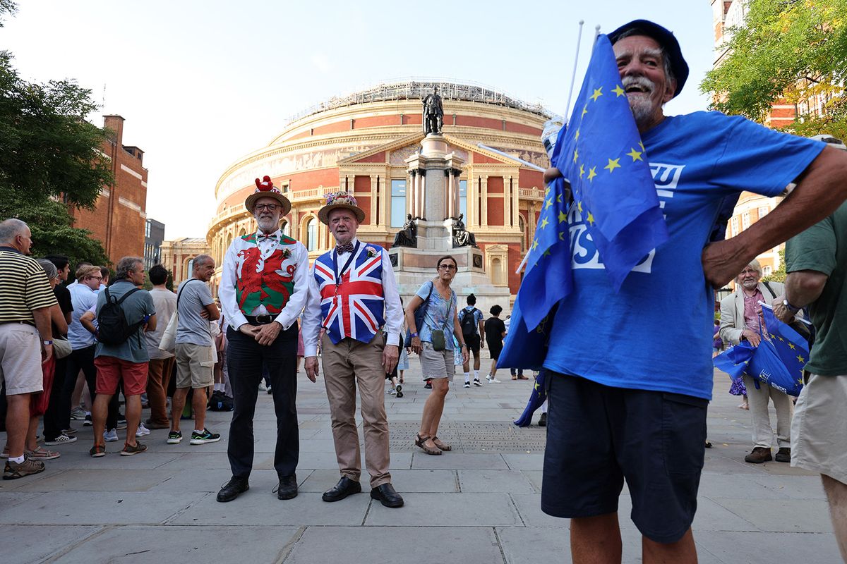 Pro-EU activists hand out EU flags as concert-goers arrive at the Royal Albert Hall in London on September 9, 2023, for the Last Night of the Proms concert. Activists distribute European flags in an anti-Brexit demonstration to concert goers outside the venue of the annual Last Night of the Proms, and the traditional Union flag flying inside in the Royal Albert Hall. (Photo by Adrian DENNIS / AFP)