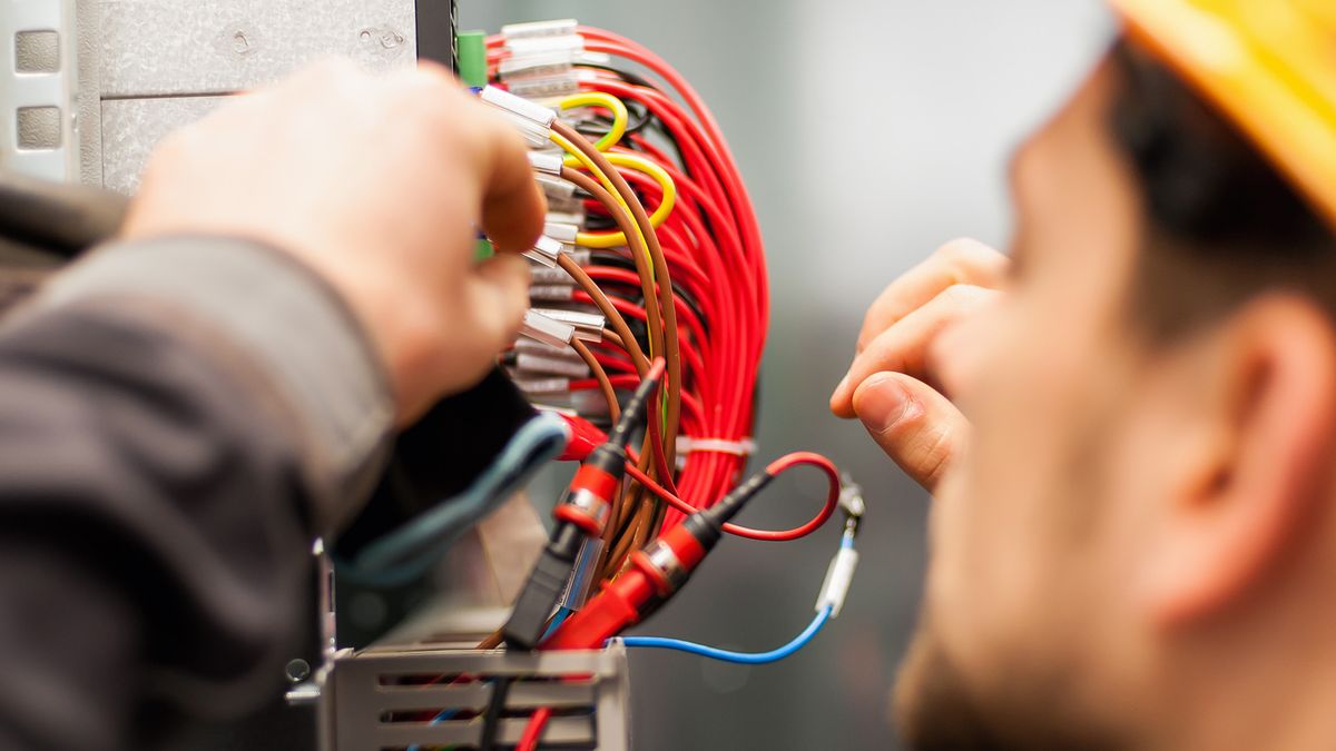 Electrician,Engineer,Tests,Electrical,Installations,And,Wires,On,Relay,ProtectionElectrician engineer tests electrical installations and wires on relay protection system. Bay control unit. Medium voltage switchgear