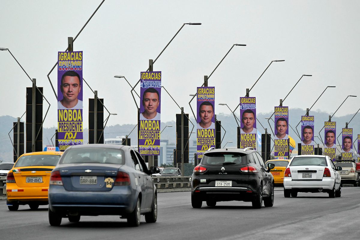 Cars drive along a bridge decorated with advertisements for Ecuador's presidential candidate of the National Democratic Action Party, Daniel Noboa, in Guayaquil, Ecuador, on October 13, 2023. Leftist frontrunner Luisa Gonzalez and challenger Daniel Noboa will face in the October 15 runoff election. (Photo by Rodrigo BUENDIA / AFP)