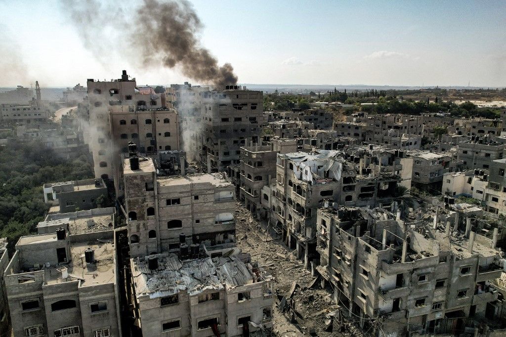 This picture taken on October 11, 2023 shows an aerial view of buildings destroyed by Israeli air strikes in the Jabalia camp for Palestinian refugees in Gaza City. Israel declared war on Hamas on October 8 following a shock land, air and sea assault by the Gaza-based Islamists. The death toll from the shock cross-border assault by Hamas militants rose to 1,200, making it the deadliest attack in the country's 75-year history, while Gaza officials reported more than 900 people killed as Israel pounded the territory with air strikes. (Photo by Yahya HASSOUNA / AFP)