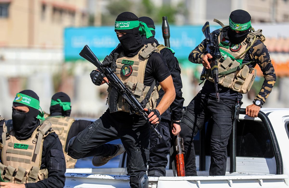 Masked,Members,Of,The,Al-qassam,Brigades,,The,Military,Wing,Of Masked members of the al-Qassam Brigades, the military wing of Hamas, during a march on the 8th anniversary of the kidnapping of the Israeli soldier Shaul Aron in 2014, Gaza City, on July 20, 2022.